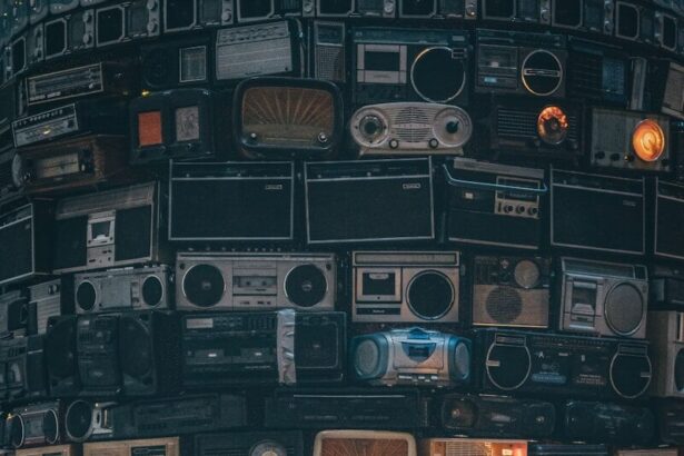a large amount of old radio's stacked on top of each other