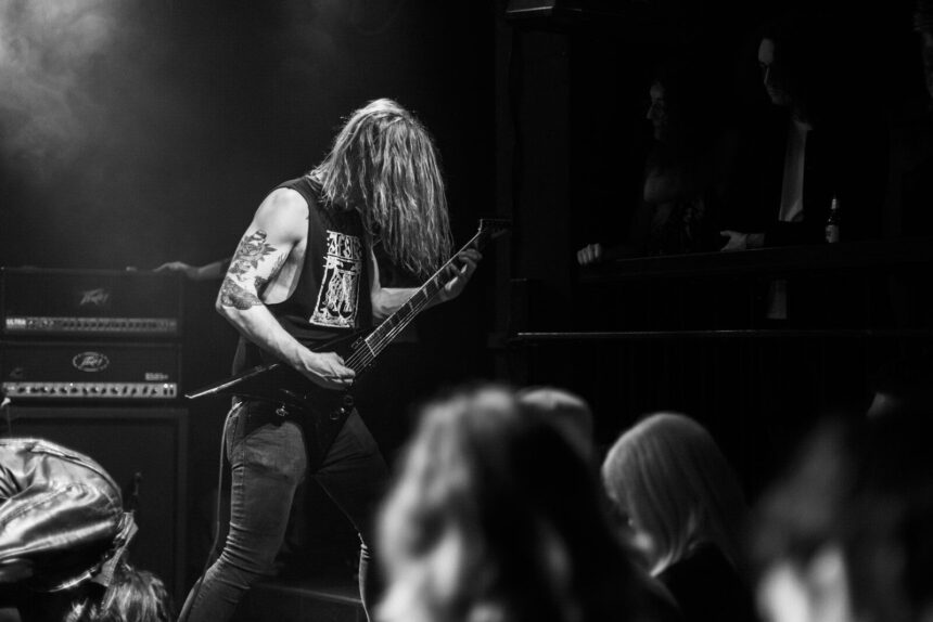 a woman playing a guitar on a stage