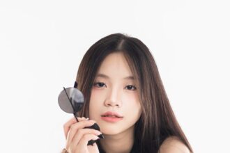 Woman poses confidently with sunglasses.