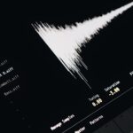 Close-up of a digital audio editing interface displaying sound waves and file names.