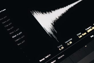 Close-up of a digital audio editing interface displaying sound waves and file names.